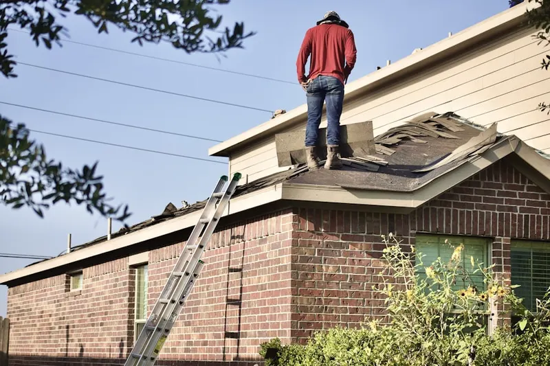 Professional roofer working on a residential roof in Oakbrook Terrace